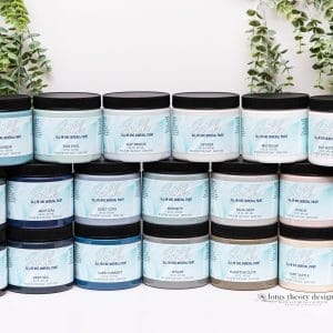 Dixie Belle Silk All-in-One Mineral Paint – mehrere Farbbehälter mit schwarzen Deckeln in zwei Reihen.